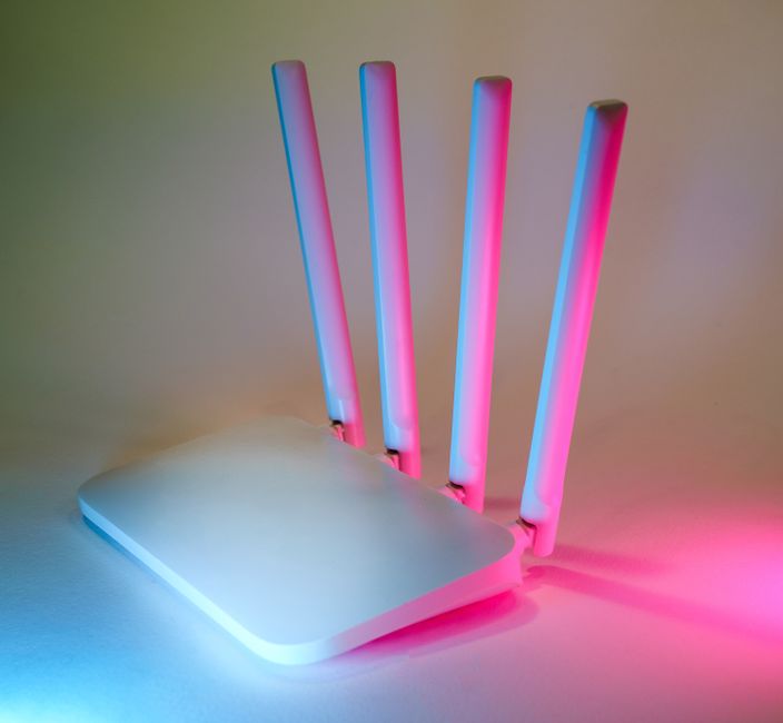 Person near a home router showing unstable internet connection